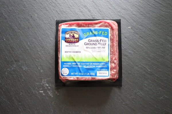 1 lb of ground beef in packaging on a slate background.