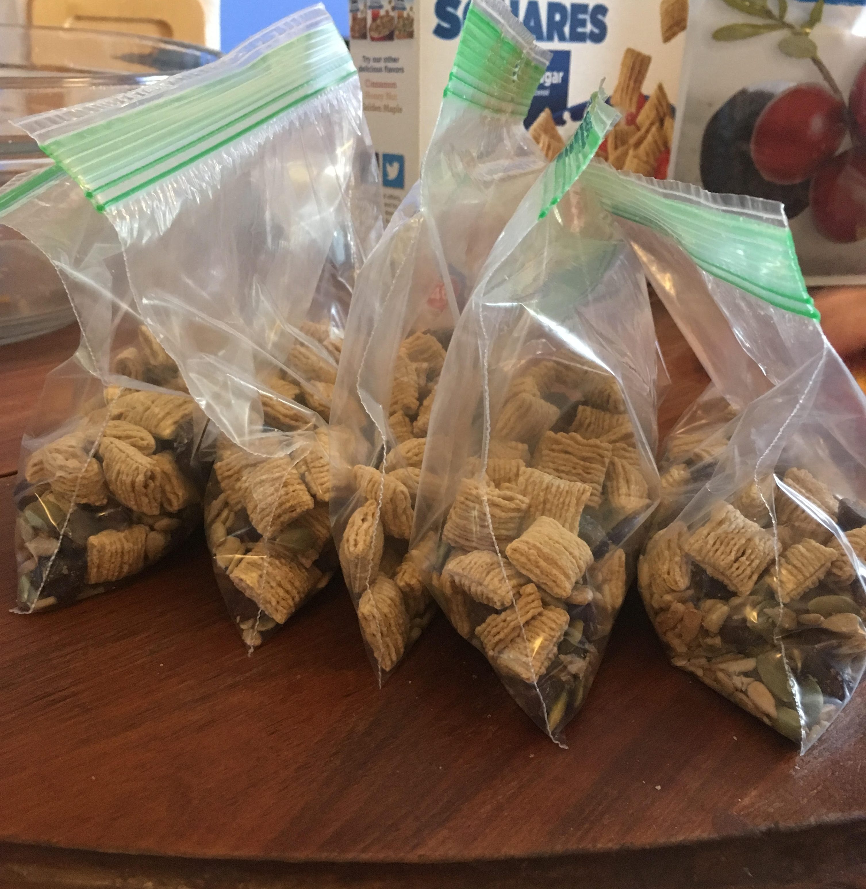 Four baggies of trail mix. 