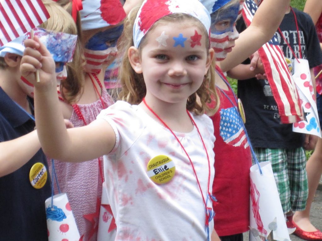 Female preschooler with blond hair dressed for the 4th of July.